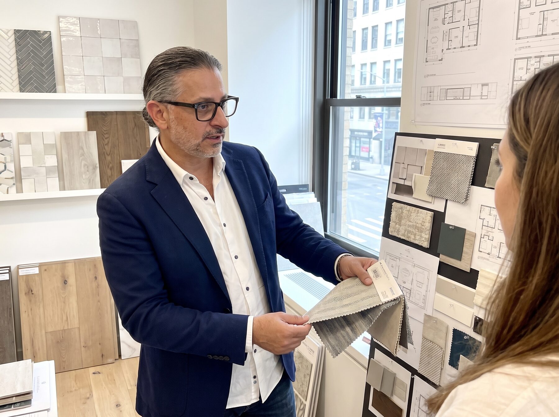 Eyal Cohen, founder of Lakeshore Designs, reviewing material samples with a client
